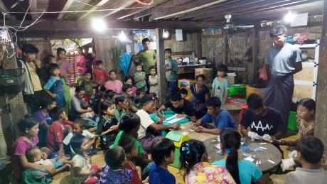 A group of people getting medical screening under electric light