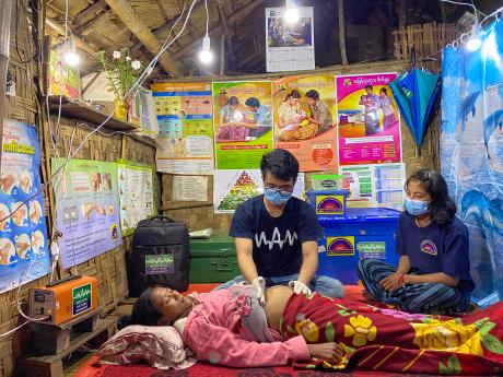 A pregnant woman receives a consultation under electric light