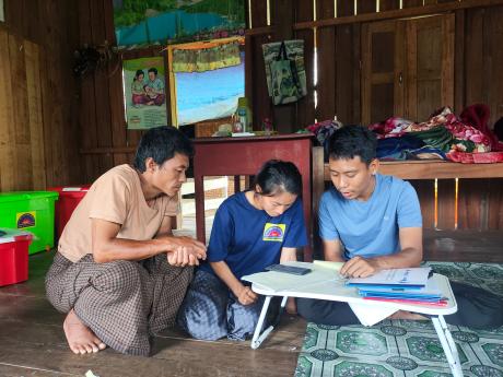 Health workers interact with smartphone at a table